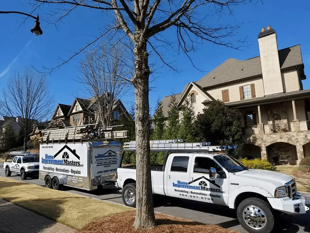home improvement master truck with trailer and truck next to two story house in canton ga