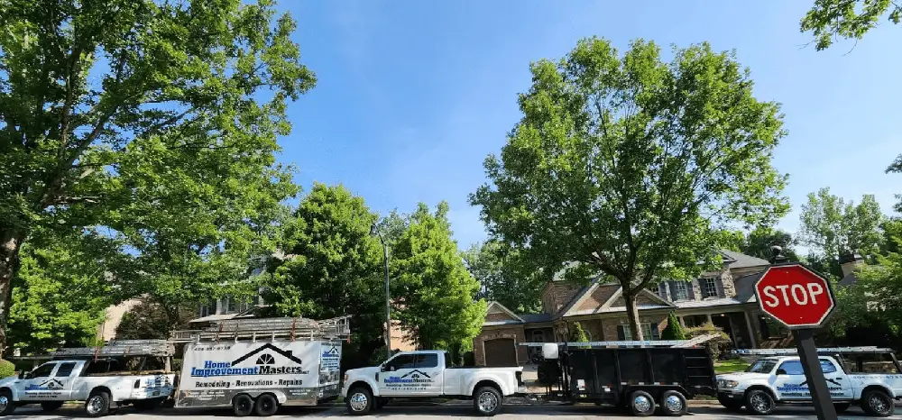 home improvement master trucks and trailer next to two houses in canton ga
