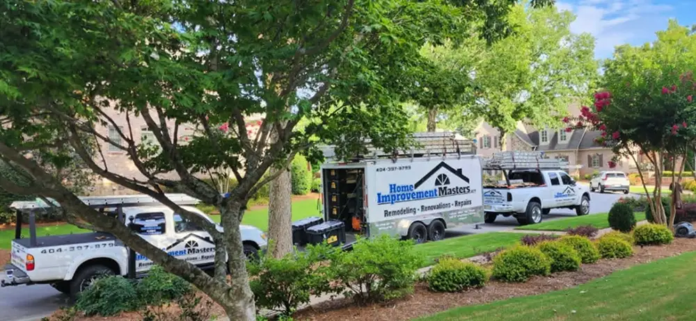 home improvement master trucks and trailer parked next to house in canton ga